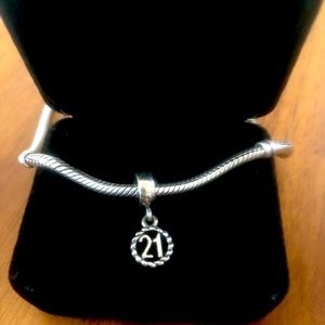 Retired Pandora “21”st birthday dangle charm.